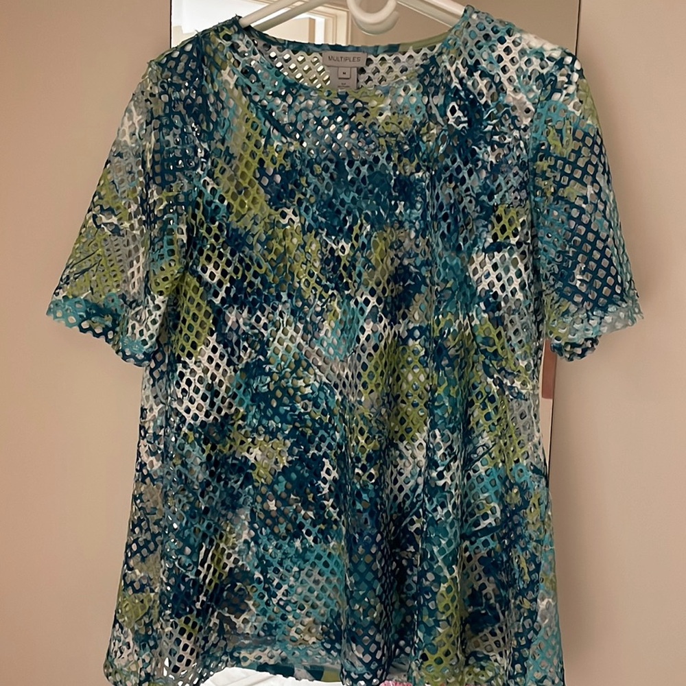 Great styling with matching tank under open weave top. Pretty blues and greens.